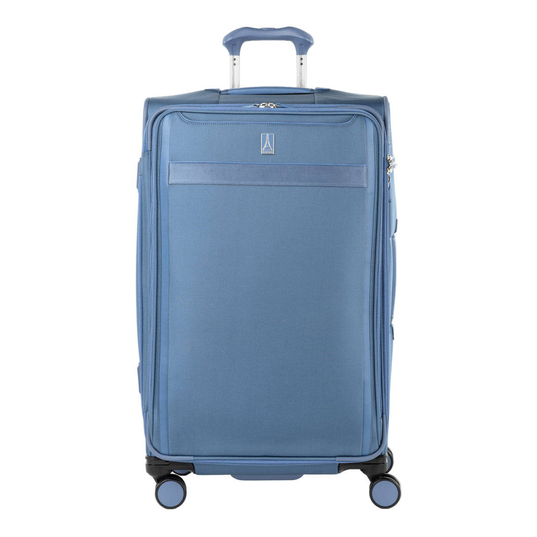 Front-facing Travelpro VersaPack+ Large Check-In Spinner in Elemental Blue, featuring smooth 360° spinner wheels and a textured handle.
